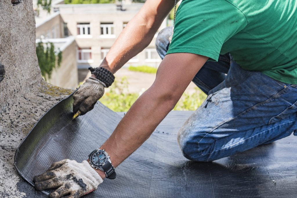 worker-performs-overhaul-roof-residential-building-scaled